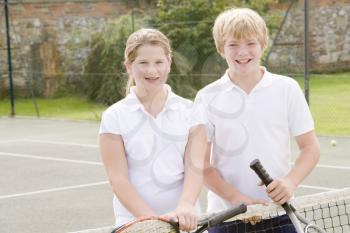Royalty Free Photo of Two Children on a Tennis Court