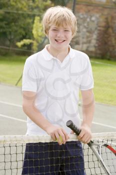 Royalty Free Photo of a Boy on a Tennis Court
