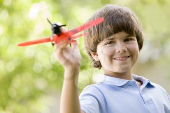 Royalty Free Photo of a Boy With a Toy Airplane