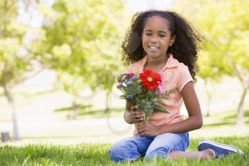 Royalty Free Clipart Image of a Girl With Flowers