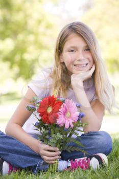 Royalty Free Photo of a Girl Holding Flowers