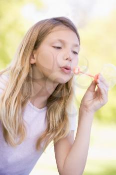 Royalty Free Photo of a Girl Blowing Bubbles