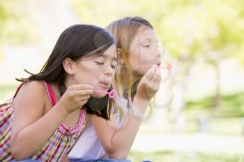 Royalty Free Photo of Two Girls Blowing Bubbles