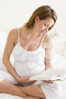 Royalty Free Photo of a Pregnant Woman Reading a Book