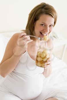 Royalty Free Photo of a Pregnant Woman Eating Pickled Eggs