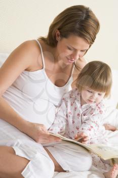 Royalty Free Photo of a Mother Reading to Her Daughter