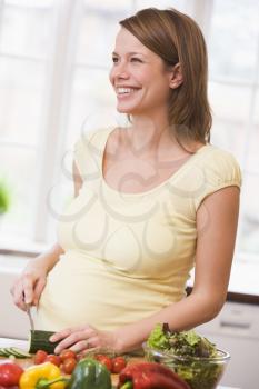 Royalty Free Photo of a Pregnant Woman in the Kitchen