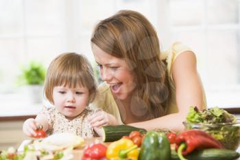 Royalty Free Photo of a Woman With Her Daughter in the Kitchen