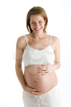 Royalty Free Photo of a Pregnant Woman Holding Her Stomach and Smiling