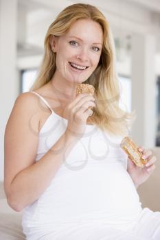 Royalty Free Photo of a Pregnant Woman Eating Bread