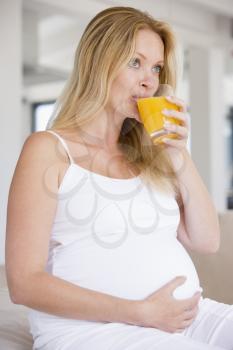 Royalty Free Photo of a Pregnant Woman Drinking Orange Juice