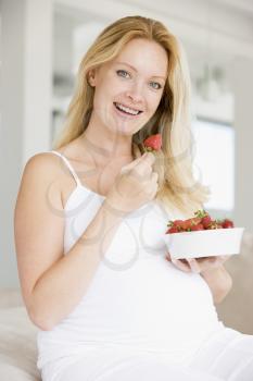 Royalty Free Photo of a Pregnant Woman With Strawberries