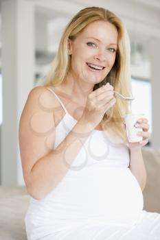 Royalty Free Photo of a Pregnant Woman With Yogourt
