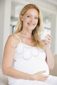 Royalty Free Photo of a Pregnant Woman Drinking Milk