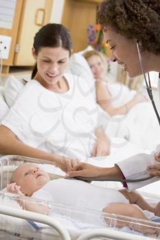 Royalty Free Photo of a Doctor Checking a New Baby