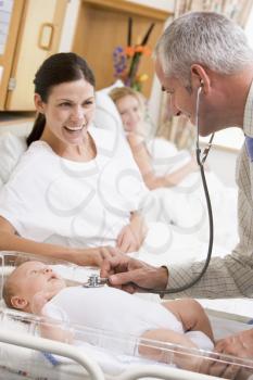 Royalty Free Photo of a Doctor Checking a Baby's Heartbeat