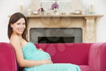 Royalty Free Photo of a Pregnant Woman in a Living Room