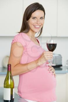 Royalty Free Photo of a Pregnant Woman Drinking Wine