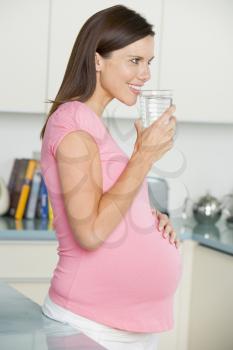 Royalty Free Photo of a Pregnant Woman Drinking Water