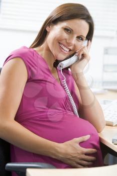 Royalty Free Photo of a Pregnant Woman on a Telephone