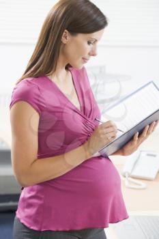 Royalty Free Photo of a Pregnant Woman With a Binder