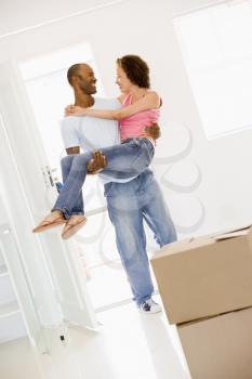 Royalty Free Photo of a Husband Carrying His Wife Over the Threshold