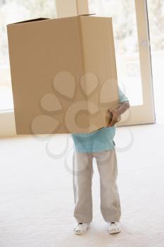 Royalty Free Photo of a Young Boy Holding a Big Box