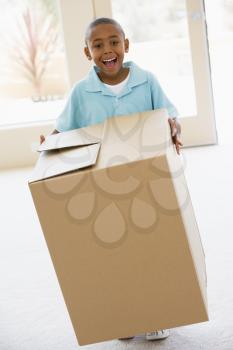 Royalty Free Photo of a Young Boy Holding a Box