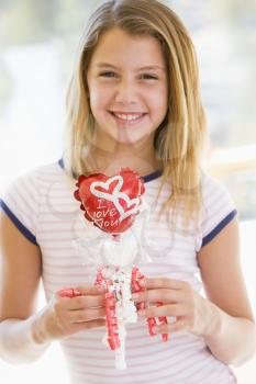 Royalty Free Photo of a Girl With a Heart Balloon
