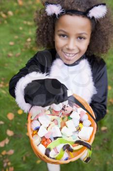 Royalty Free Photo of a Girl in a Cat Costume With Treats
