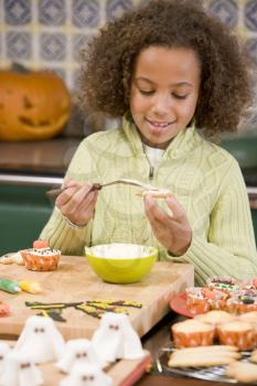 Royalty Free Photo of a Young Girl Making Halloween Treats