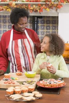 Royalty Free Photo of a Grandmother and Granddaughter Making Halloween Treats