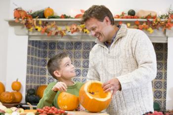 Royalty Free Photo of a Father and Son Carving Pumpkins