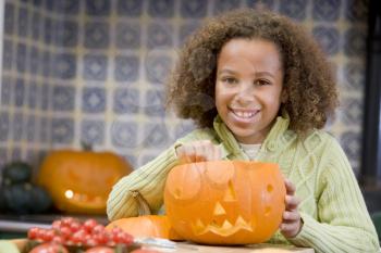 Royalty Free Photo of a Young Girl With a Jack-o-Lantern