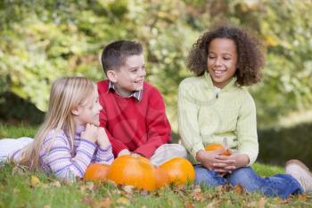 Royalty Free Photo of Three Children With Pumpkins