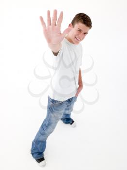 Teenage boy standing with hand up smiling