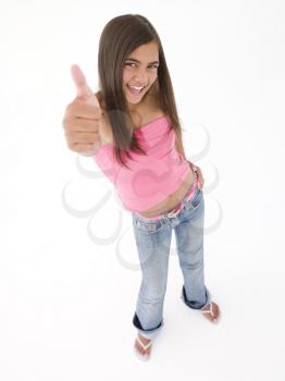 Young girl giving thumbs up smiling