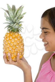 Royalty Free Photo of a Girl With a Pineapple