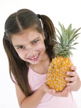 Royalty Free Photo of a Girl Holding a Pineapple