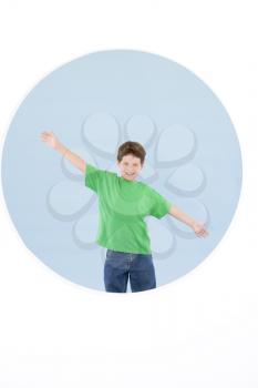 Royalty Free Photo of a Boy Standing With His Arms Spread