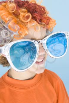 Royalty Free Photo of a Boy in a Clown Wig and Big Sunglasses