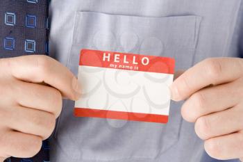 Royalty Free Photo of a Man Attaching a Name Tag