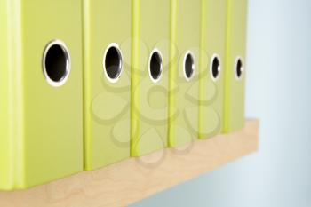 Royalty Free Photo of a Row of Green Binders