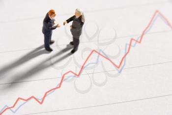Royalty Free Photo of Businessman Figurines Beside a Graph
