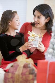 Royalty Free Photo of a Girl Giving Her Mother a Christmas Gift
