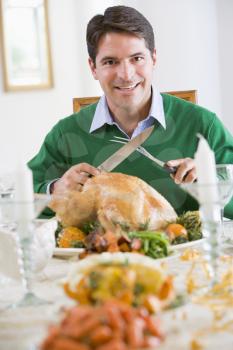 Royalty Free Photo of a Man Carving a Turkey
