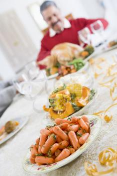 Royalty Free Photo of a Man Craving a Turkey at the Christmas Table