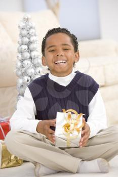 Royalty Free Photo of a Boy With a Christmas Gift
