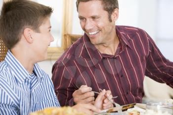 Royalty Free Photo of a Father and Son Having Dinner