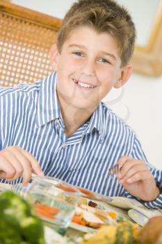 Royalty Free Photo of a Boy Having Christmas Dinner